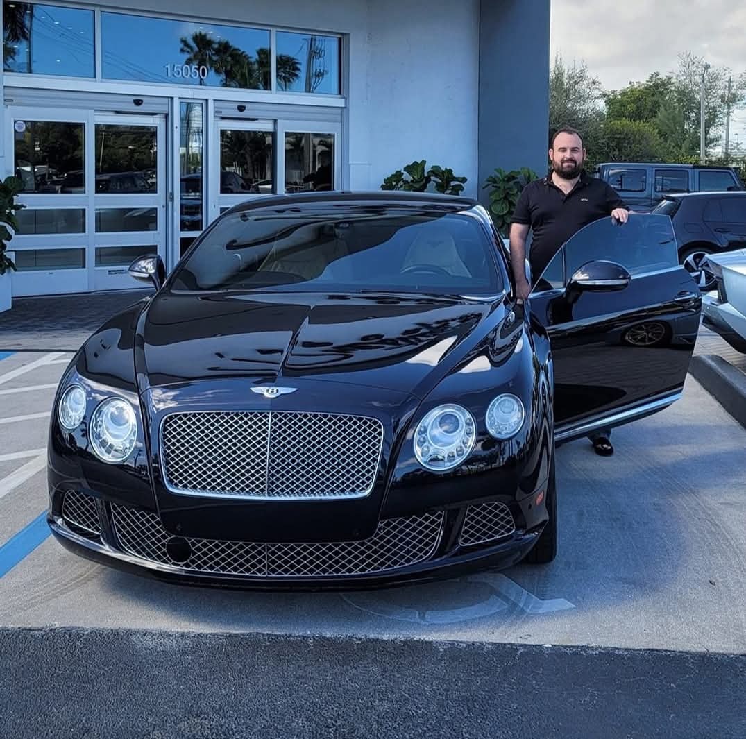 Rob standing with black Bentley Continental GT